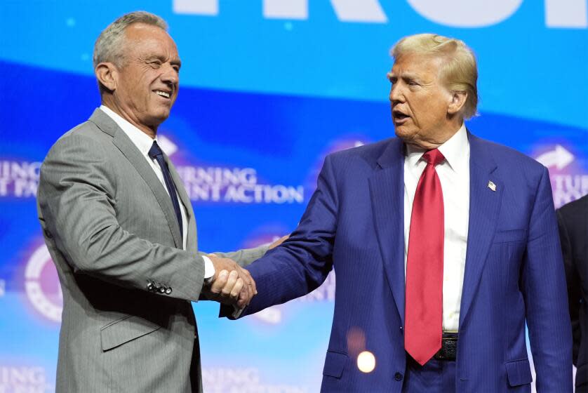 Former President Trump shakes hands with Robert F. Kennedy Jr. at a campaign rally in October in Duluth, Ga. (Alex Brandon / Associated Press)