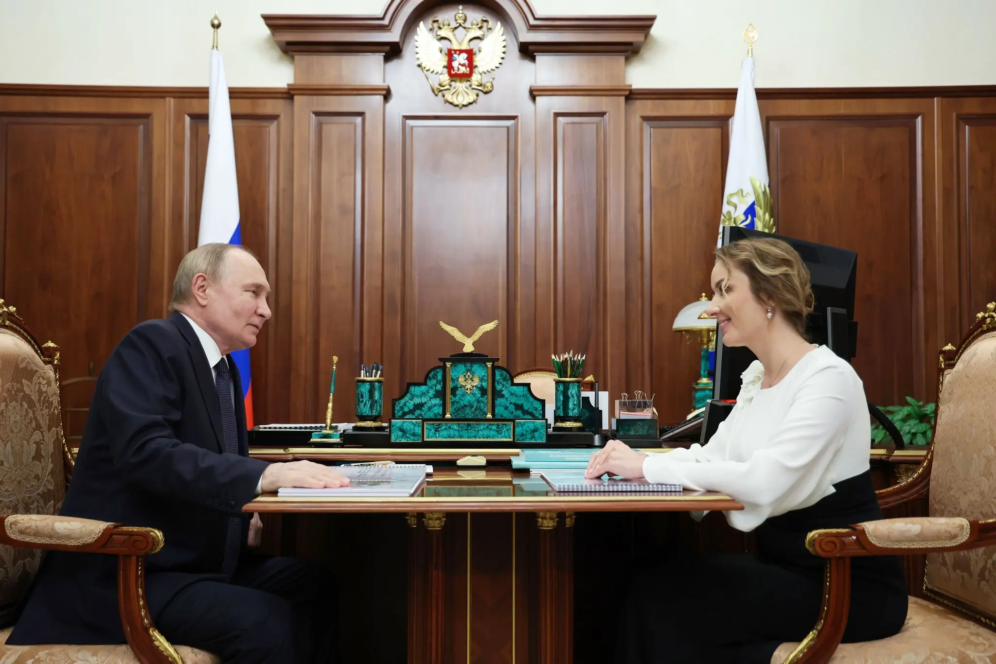 President Vladimir V. Putin of Russia and his commissioner for children, Maria Lvova-Belova, in a photo released by the Russian state news media in May. The International Criminal Court has issued warrants for their arrest.Credit...Alexander Kazakov/Sputnik, via Shutterstock