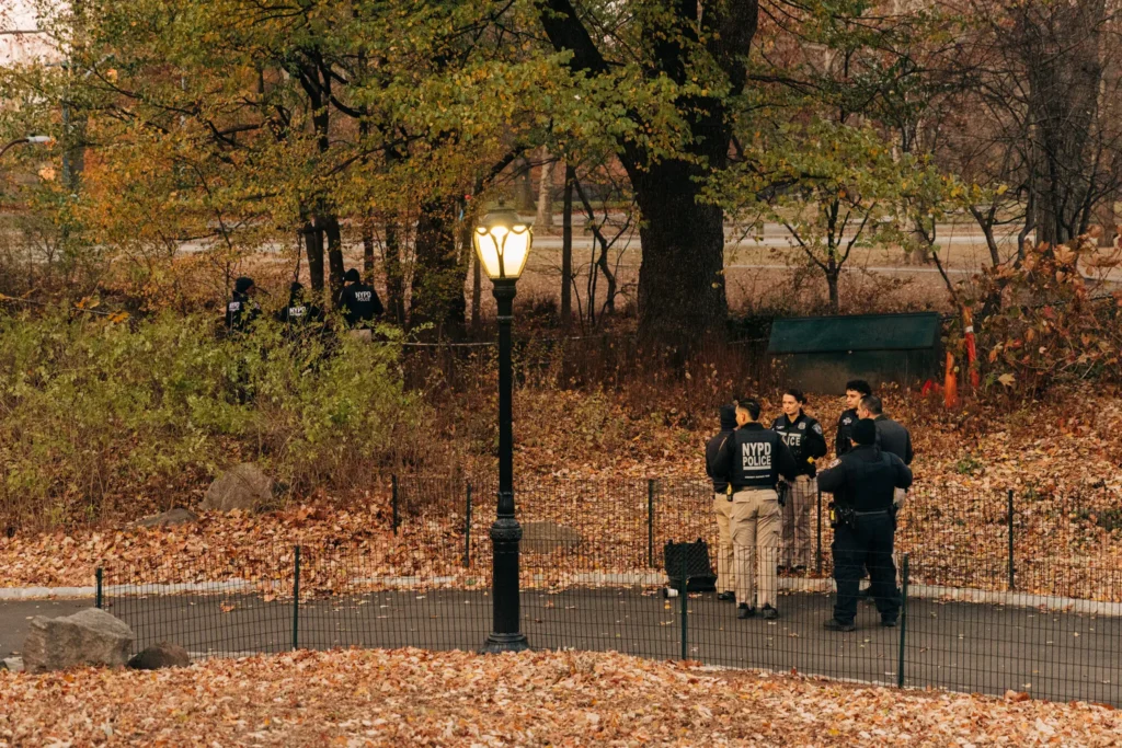 Police officers searching for the gunman’s backpack in Central Park on Friday.Credit...Jeenah Moon for The New York Times