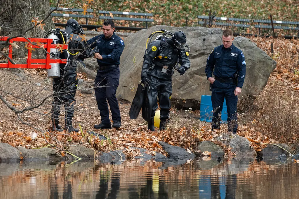 New York Police Department divers looked for a gun in Central Park in Manhattan. The police in Pennsylvania seized a weapon when they arrested a suspect, Luigi Mangione, on Monday.Credit...Brittainy Newman for The New York Times