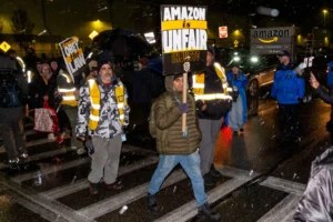 Workers at Amazon’s fulfillment center in Staten Island picketing after walking off the job after midnight on Saturday morning.Credit...Dakota Santiago for The New York Times