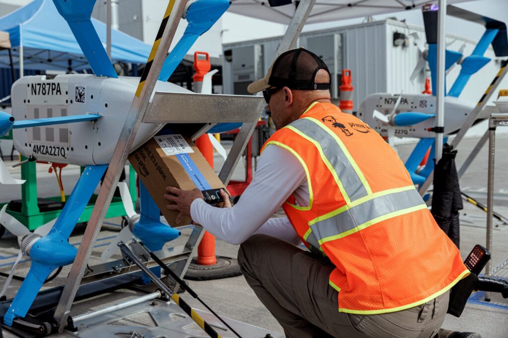 An Amazon employee preparing a drone to deliver an order at the Prime Air Drone Delivery Center.