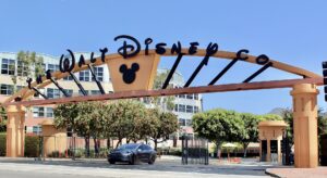 The Alameda Avenue entrance to the Walt Disney Studios in Burbank, California. This was taken just after a major renovation in summer 2016, in which the dated tropical pastels of the gateway arch were replaced with a more conservative orange-and-black color scheme and Mickey Mouse was added to the arch. Photographed on July 11, 2016 by user Coolcaesar.