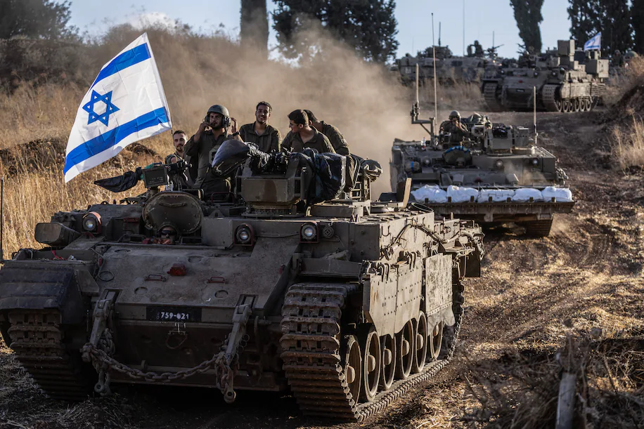 A convoy of Israeli tanks heads toward the Lebanese border on Oct. 1. (Heidi Levine for The Washington Post)