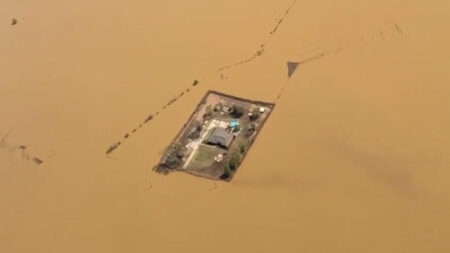 A Tennessee home is surrounded by floodwaters on April 8. It has a levee system that helped protect it from flooding during storms earlier this month. (Randy Moore /Storyful)