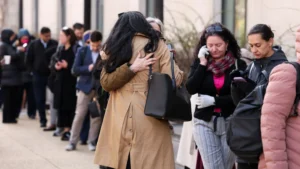 Employees of the Department of Health and Human Services (HHS) hug each other as they queue outside the Mary E. Switzer Memorial Building, after it was reported that the Trump administration fired staff at the Centers for Disease Control and Prevention and at the Food and Drug Administration, as it embarked on its plan to cut 10,000 jobs at HHS, in Washington, D.C., U.S., April 1, 2025. (Kevin Lamarque/Reuters)