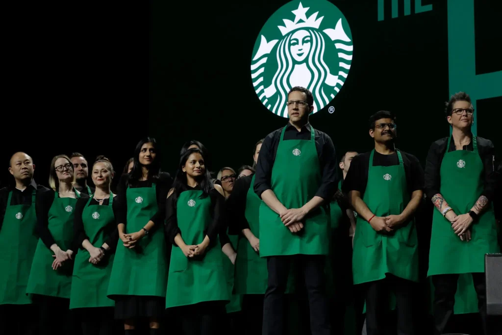 Starbucks baristas, seen here during an annual shareholders meeting in Seattle in 2019, have staged walkouts over dress code restrictions at more than 100 coffee shops. (Ted S. Warren/Associated Press)