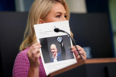 White House press secretary Karoline Leavitt holds a news article on Amazon CEO Jeff Bezos as she speaks during the daily press briefing at the White House on April 29, 2025. (ANDREW HARNIK—GETTY IMAGES)