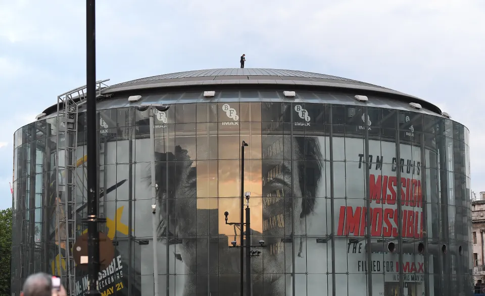Tom can be seen on the roof of the cinema, which had a huge wrap-around poster promoting Mission: Impossible — The Final Reckoning, which is set for release next weekCredit. (Goff)