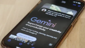 Google's Gemini AI chatbot shown on a phone in March 2024 in New York City. Google is now using a version of its Gemini AI model to fight scams on Chrome and Search. (Michael M. Santiago/Getty Images/File)