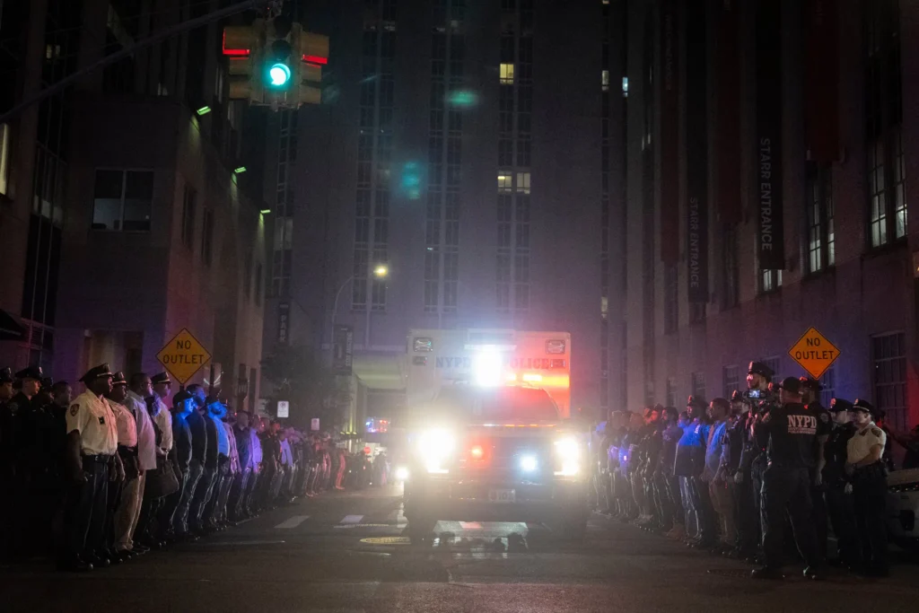 An ambulance carrying the body of Didarul Islam, a police officer killed in the Midtown shooting, in Manhattan early Tuesday. © Vincent Alban/The New York Times