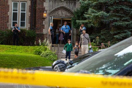 Police respond at Annunciation School after a man killed two children and injured several others Wednesday, Aug. 27, 2025 in Minneapolis. © Photo by Nicole Neri/Minnesota Reformer