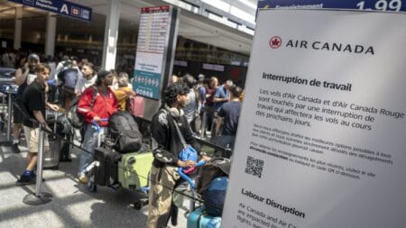 Passengers wait in line to speak with Air Canada representatives at the Pierre-Elliott Trudeau Airport in Montreal on August 15. © ANDREJ IVANOV/AFP via Getty Images