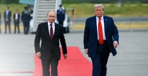 U.S. President Donald Trump and Russian President Vladimir Putin walk on the tarmac after they arrived at Joint Base Elmendorf-Richardson in Anchorage, Alaska, on Aug.15, 2025. © Andrew Caballero-reynolds/AFP via Getty Images