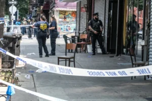Three Killed, Nine Wounded in Brooklyn Nightclub Shooting Members of the New York City Police Department investigate a shooting scene at Taste of the City lounge in the Crown Heights neighborhood of the Brooklyn borough in New York City on Aug. 17, 2025. © Stephanie Keith/Getty Images