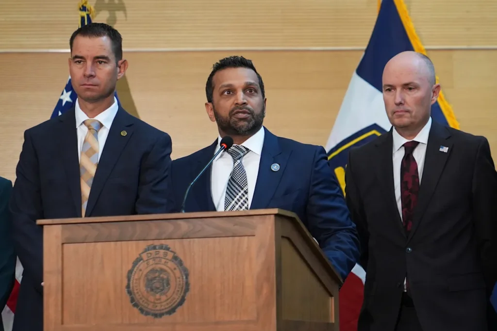 Kash Patel speaks at a news conference, Friday, Sept. 12, 2025, in Orem, Utah, as Utah department of public safety commissioner Beau Mason, left, and Utah Gov. Spencer Cox listen. © AP Photo/Lindsey Wasson
