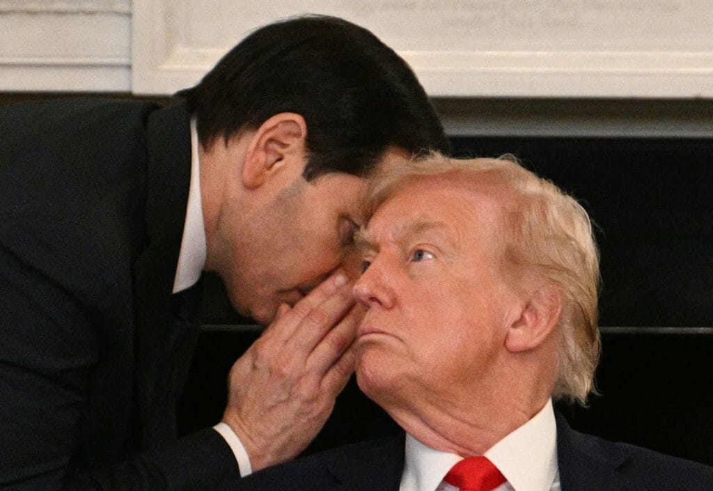 Secretary of State Marco Rubio whispers in the ear of President Donald Trump on Wednesday at the White House. © Jim Watson/AFP/Getty Images