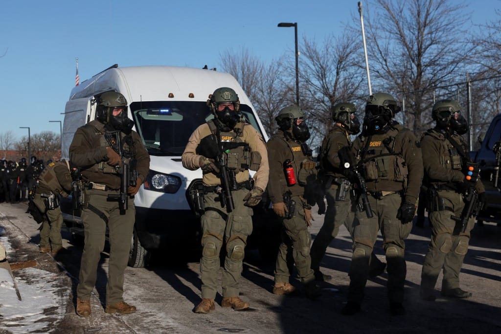 Law enforcement stand guard while people protest outside the Bishop Henry Whipple Federal Building, after the fatal shootings of Renee Nicole Good and Alex Pretti by federal immigration agents, in Minneapolis, Minnesota, U.S., January 30, 2026. (Reuters)
