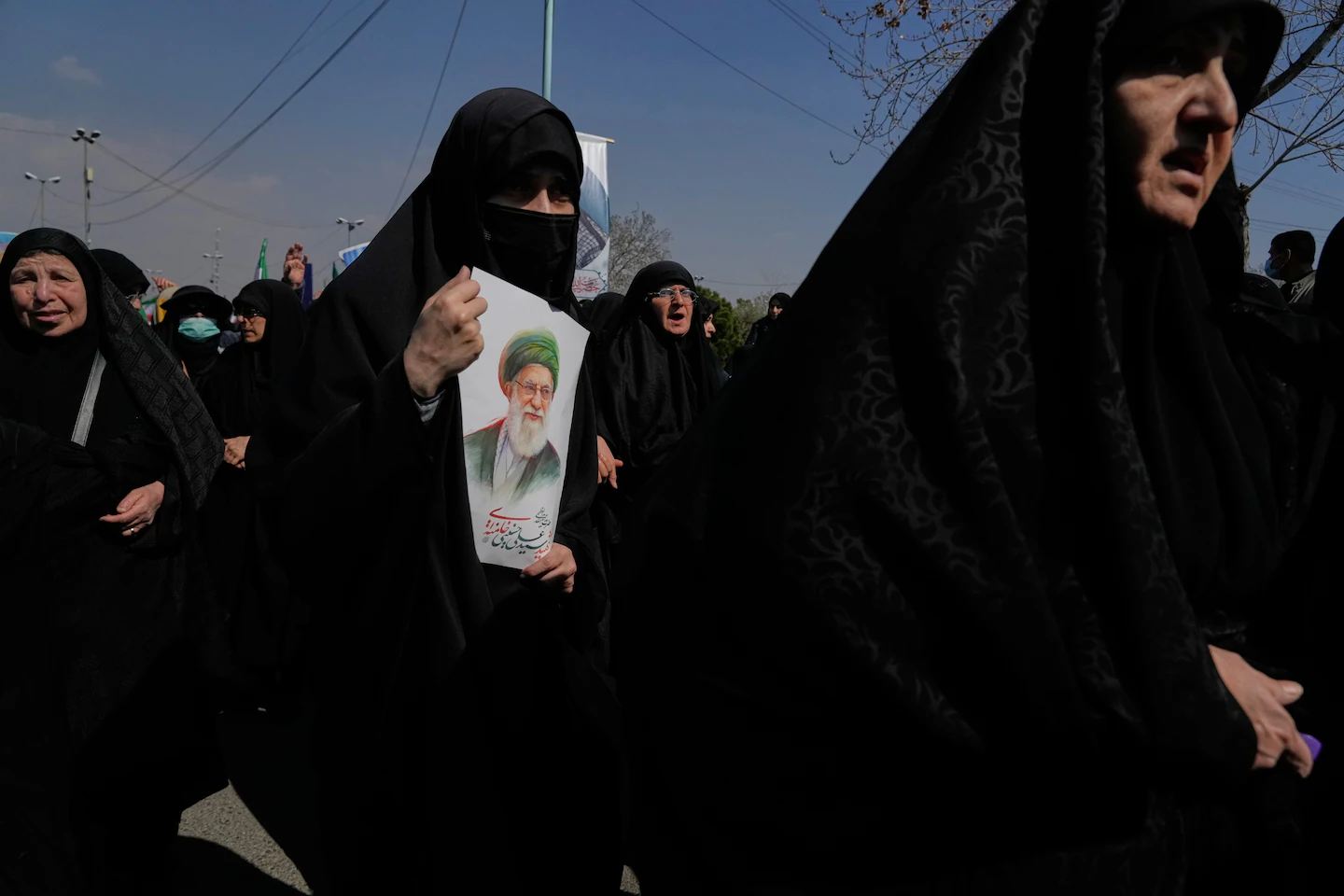 Pro-government demonstrators march against the U.S.-Israeli military campaign in Tehran on Friday. A classified U.S. report recently predicted that the Iranian regime would be able to hold onto power even if the United States attacked. (Vahid Salemi/AP)