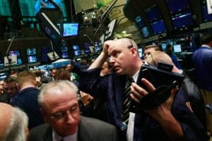 Traders work on the floor moments before the morning bell at the New York Stock Exchange November 21, 2008 in New York City. (Photo by Mario Tama/Getty Images)