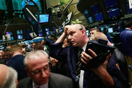 Traders work on the floor moments before the morning bell at the New York Stock Exchange November 21, 2008 in New York City. (Photo by Mario Tama/Getty Images)