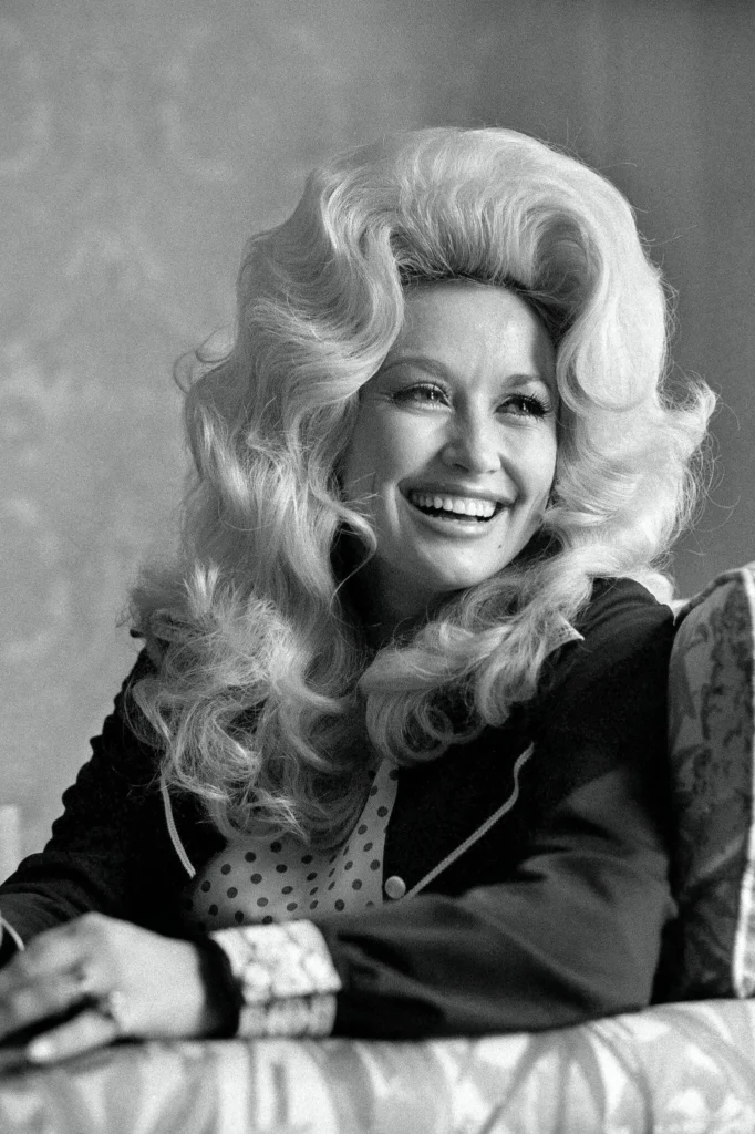 Dolly Parton in 1975. She was likened to the Big Rock Candy Mountain, the Depression-era symbol of abundance. Her music confronted privation and loss even as it radiated possibility and hope. (Jack Manning/The New York Times)