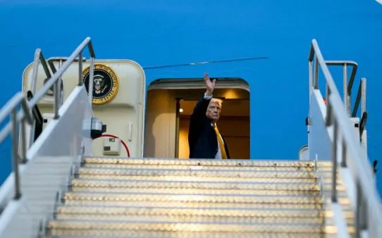 Mr Trump waved at crowds as he boarded Air Force One before being smuggled off the aircraft. (Daniel Torok)