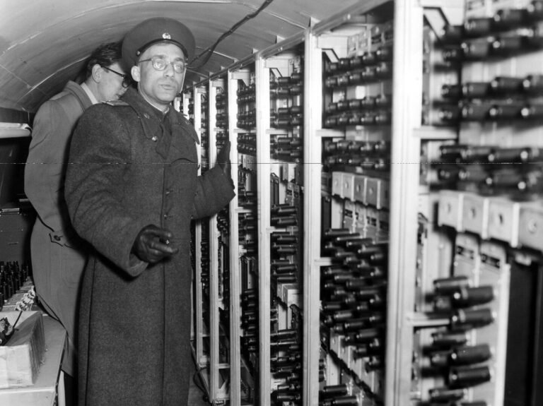 In 1956, a Soviet Signal Corps officer displays equipment in a tunnel dug by Britain and the United States from Berlin’s American sector to the Soviet sector, used to tap Soviet communications. A spy in Britain’s intelligence service alerted Moscow to the tunnel. (AP-Photo/Kreusch)