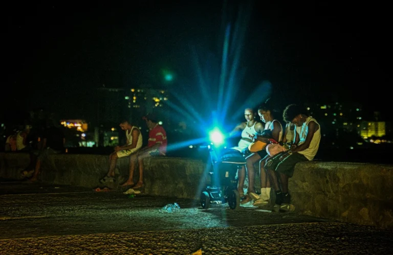 Two shipments of Russian oil and gas head to Cuba in defiance of US People gather at the waterfront during a blackout in Havana on March 16, 2026. (Photo by ADALBERTO ROQUE / AFP)